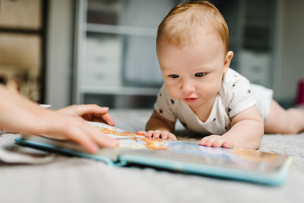 Baby boy looking at book