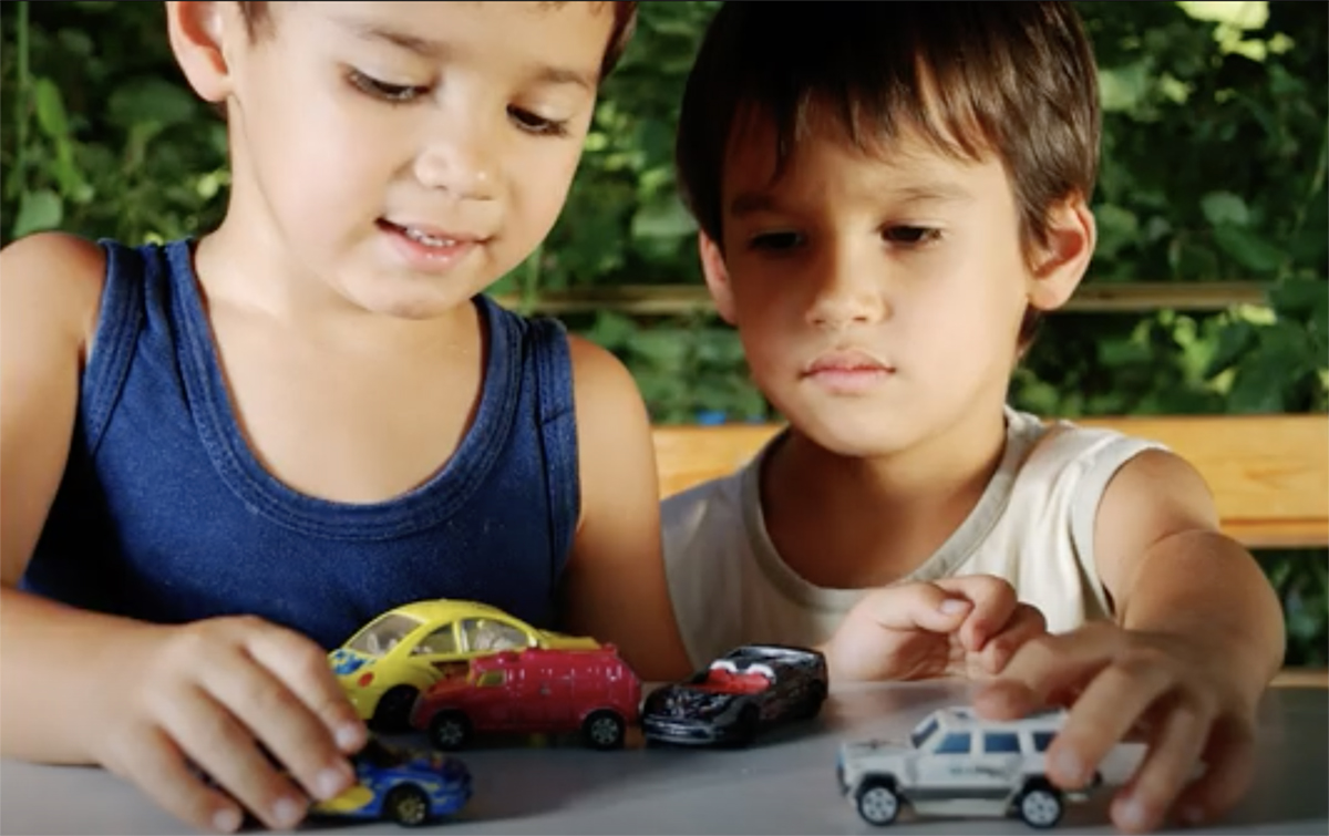 Girl and Boy playing with cars